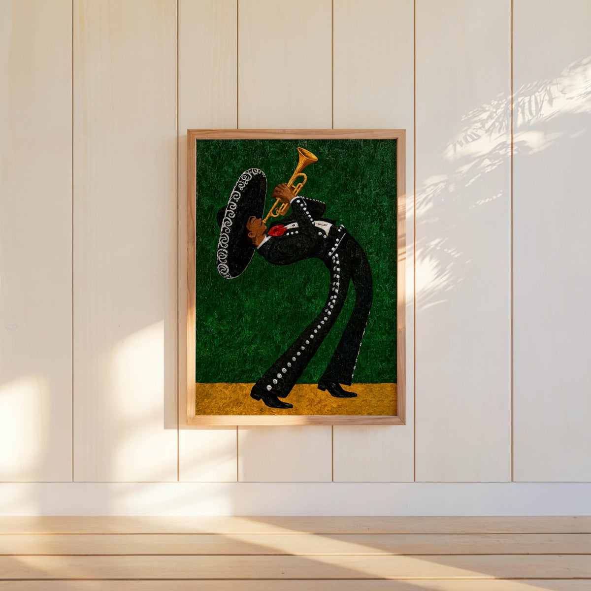 Emerald green mariachi wall art print hung on white panel, textured glitter background and gold lower band catching light