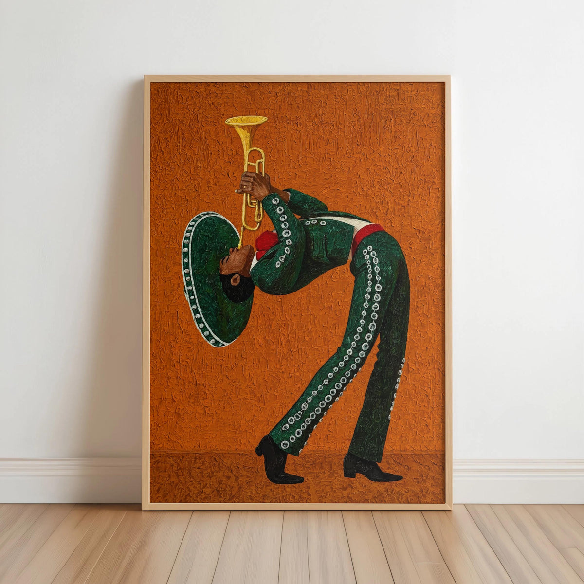 Framed mariachi wall art on white floor, deep green charro suit playing trumpet against orange.