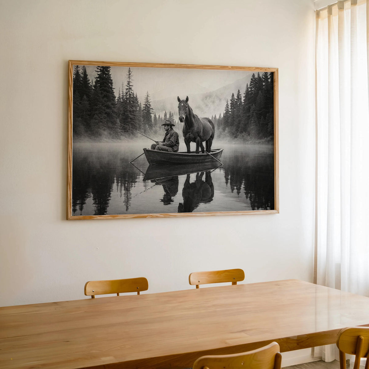 Large framed cowboy and horse wall art above a wood dining table, modern rustic wall decor in monochrome