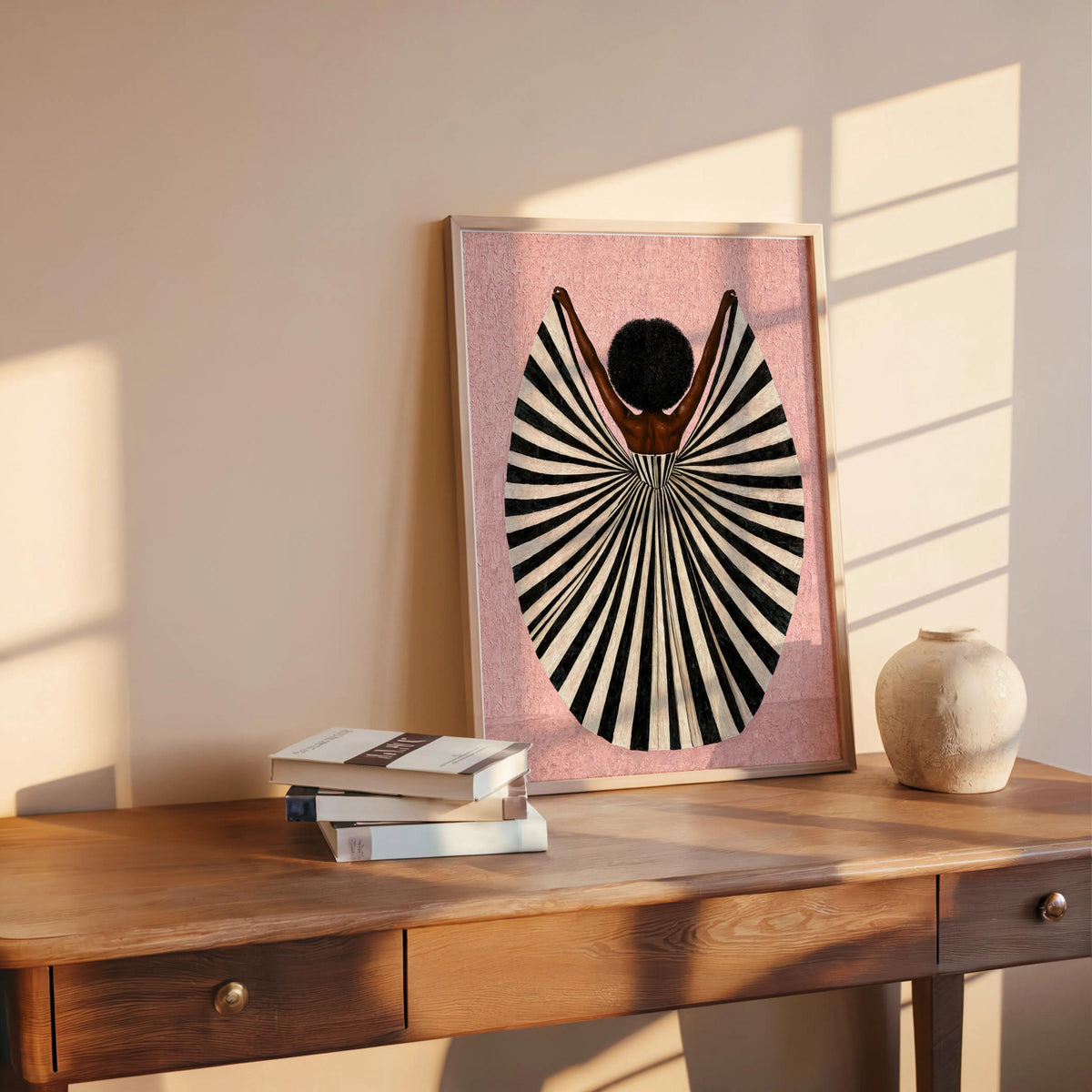 Pink poster propped on wood shelf with books and vase, feminine palette and bold silhouette, abstract black woman wall art