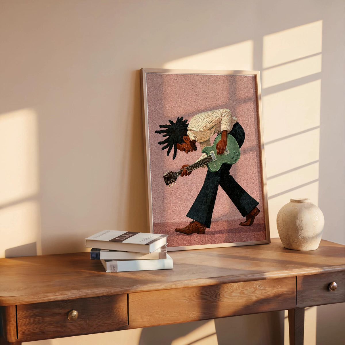 Pink background print propped on wooden table, warm sunlight, colorful music room art, guitarist wall decor