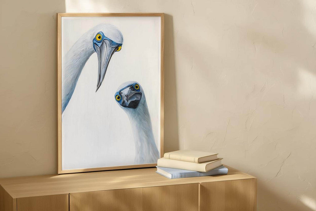 Frame leaning against cream wall with daylight, playful bird expressions emphasized, funny bird wall art, blue footed booby wall art print