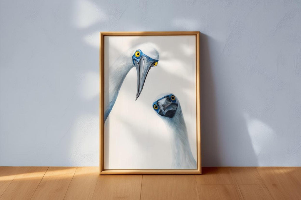 Frame propped on wood floor with strong side light, close view of expressive birds, funny animal art print, blue footed booby wall art print