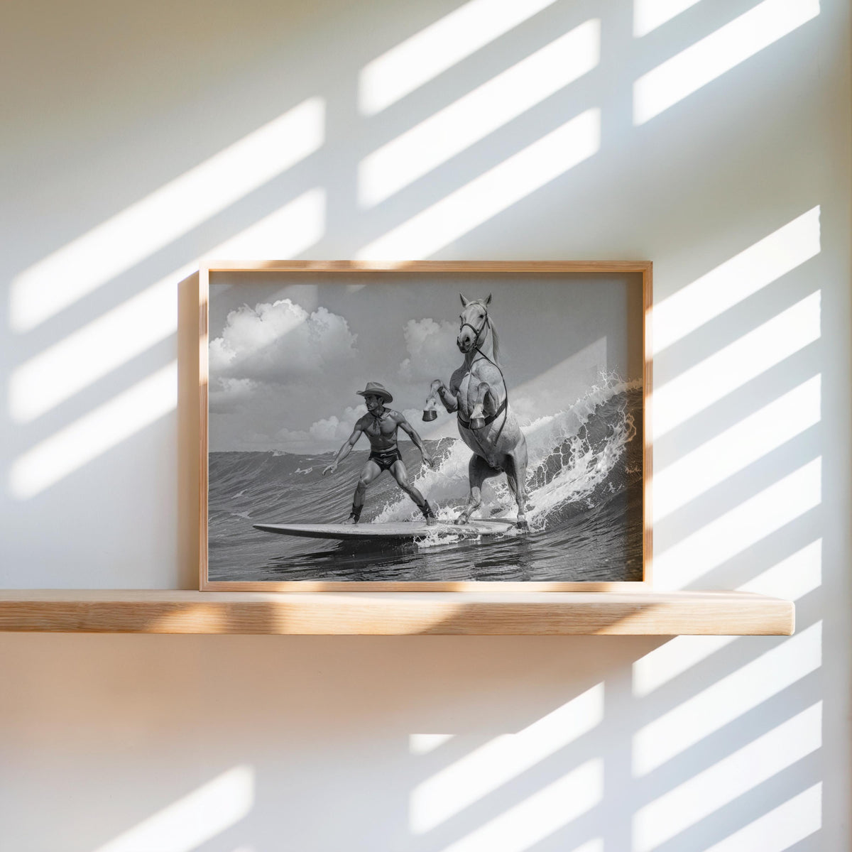 Small framed cowboy surfing wall art on sunlit floating shelf, coastal western decor styling