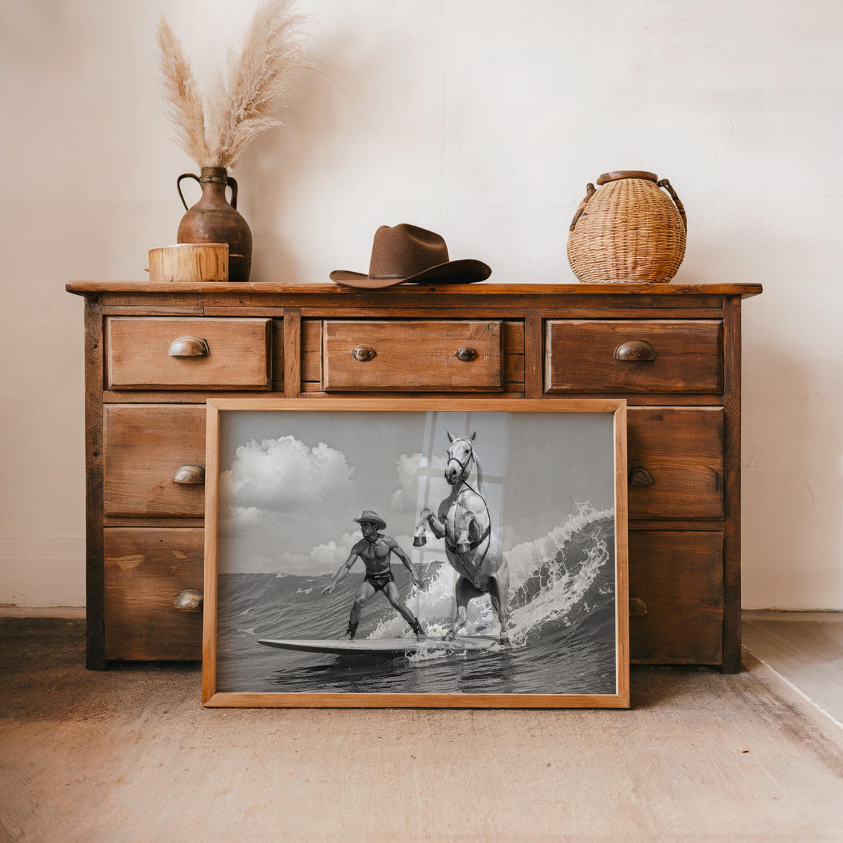 Cowboy surfing wall art displayed on vintage dresser with hat, western beach wall art vibe