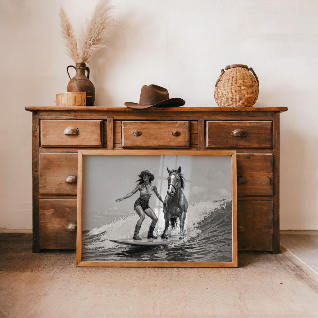 Cowgirl horse wall art leaning against a rustic dresser, coastal western mood, monochrome equestrian print