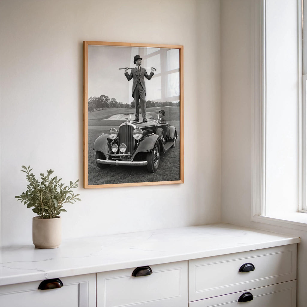 Slim hallway view with framed retro golfer poster above a dresser, classic car wall art, refined masculine decor
