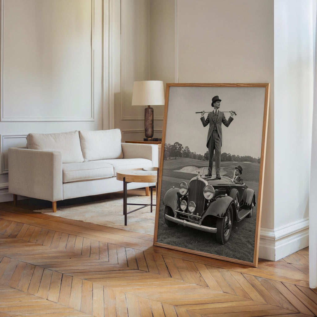 Full-room scene, large framed vintage golf poster leaning on parquet floor, dapper golfer and convertible car