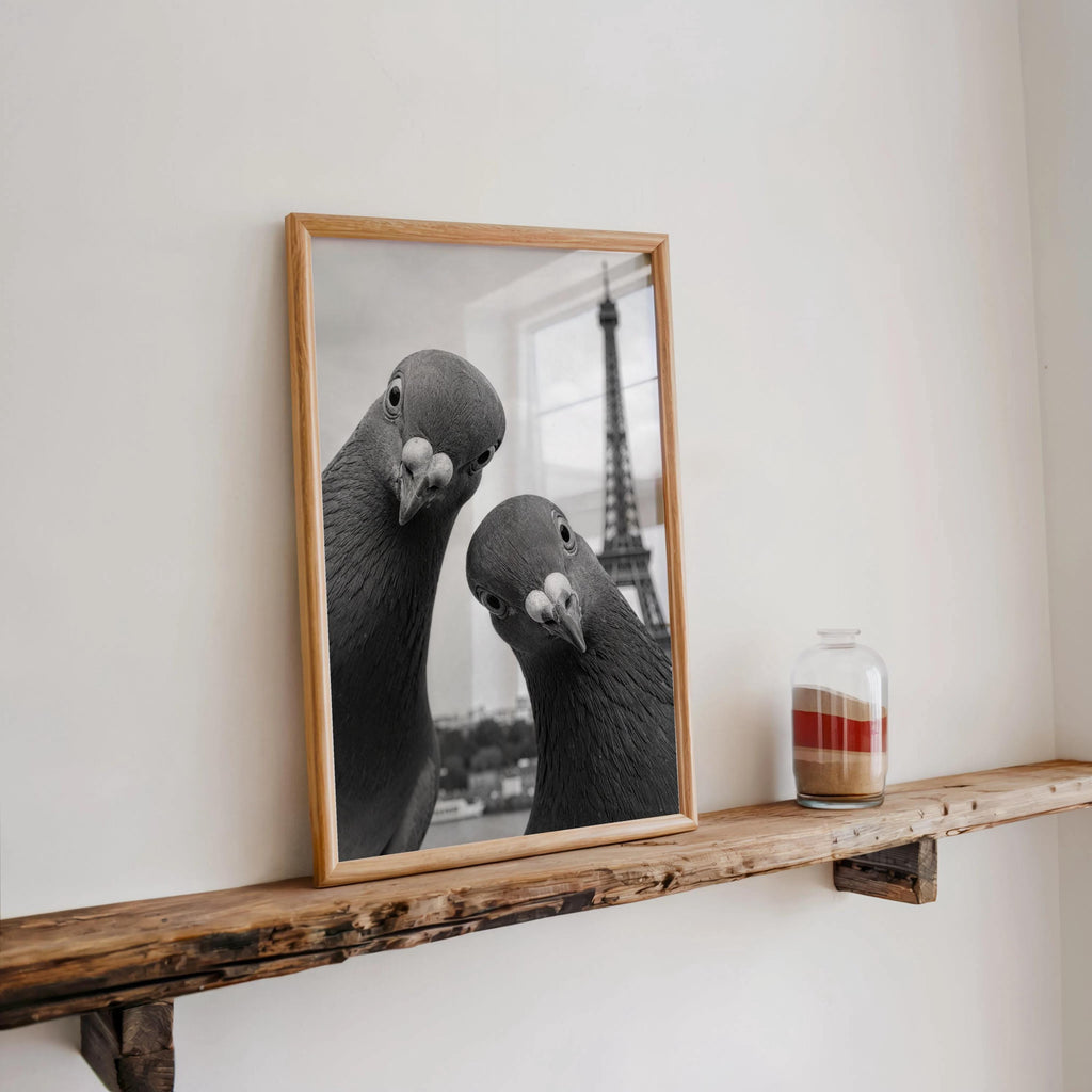 Rustic floating ledge displaying framed pigeon print with a candle and jar, Paris travel wall decor meets quirky animal wall art