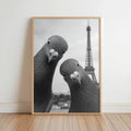 Black and white portrait print in a light wood frame leaning on floor, pigeons with Eiffel Tower, funny pigeon wall art