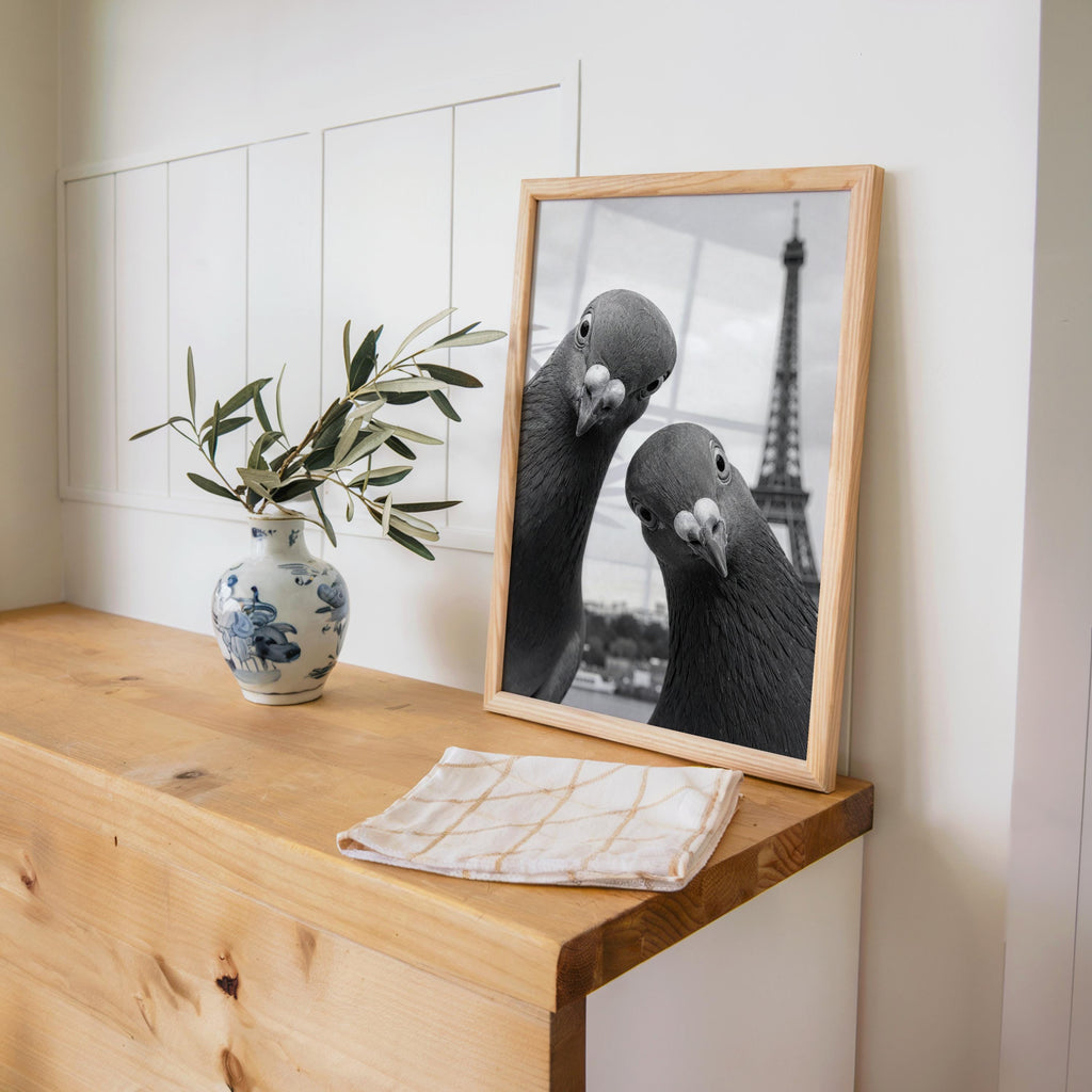 Wood desk vignette with leaning framed pigeon print, ceramic vase and plant, cozy workspace styling, pigeon art print, funny pigeon wall art