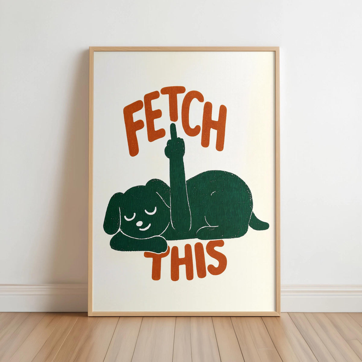 Framed cream print on floor, forest green relaxed dog silhouette, orange vintage FETCH THIS text, funny dog wall art