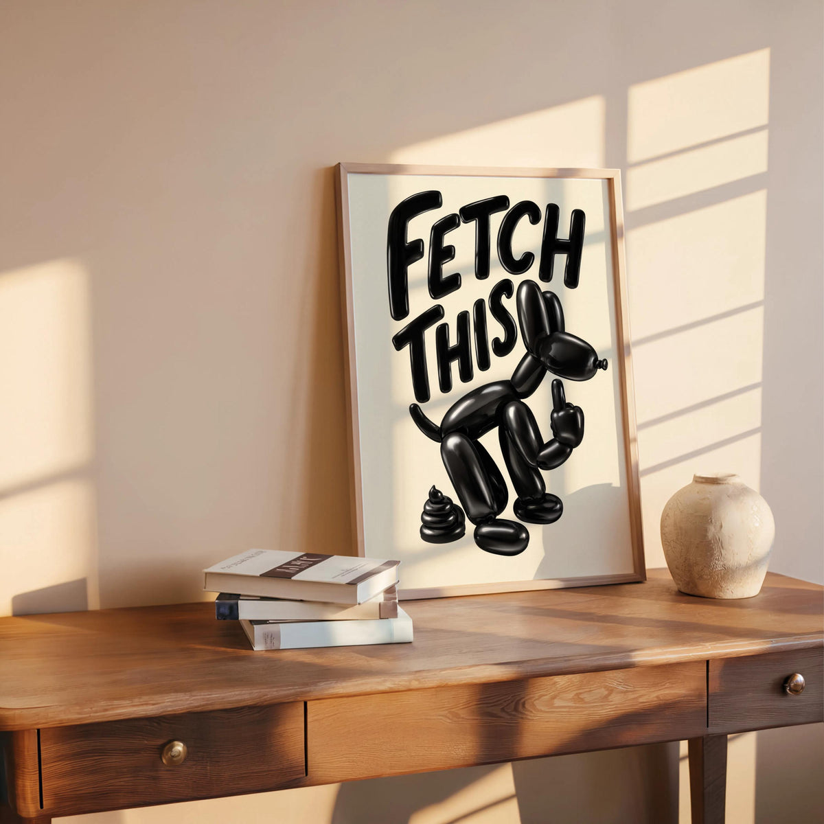 Print resting on a wooden desk with books and warm sun, glossy middle finger dog motif, funny balloon dog wall art