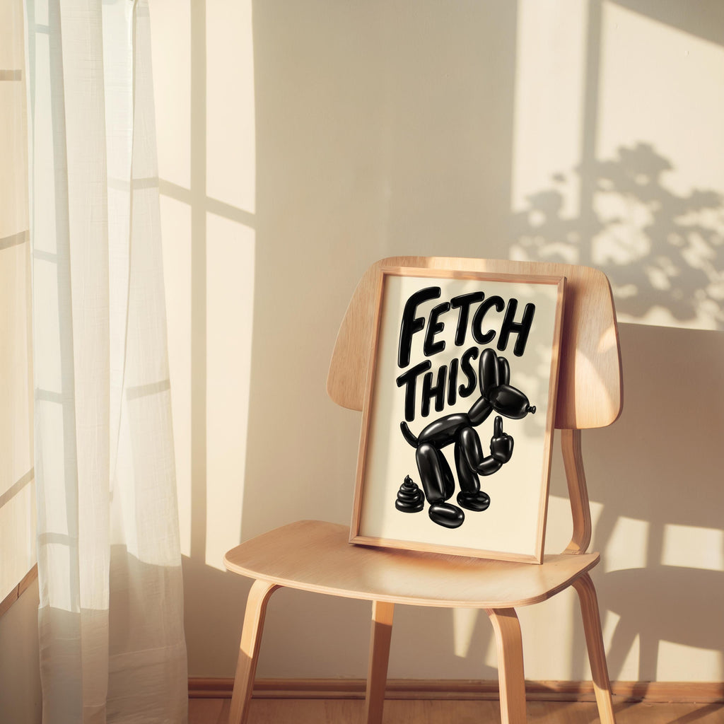 Small chair by a curtained window holds the print, playful black balloon dog showing a rude gesture, middle finger dog art