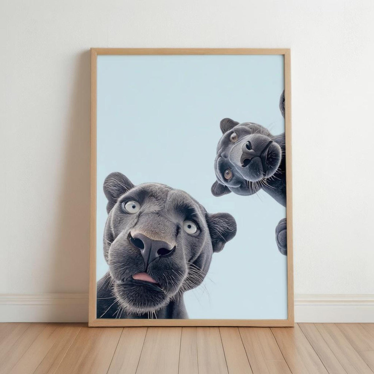 Wood frame black panther nursery wall art leaning on pale wall, two playful panthers peek