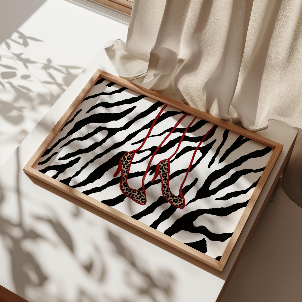 Wooden frame on table with soft light, black and white zebra pattern, dangling leopard print heels, leopard print heels art, leopard heels wall art