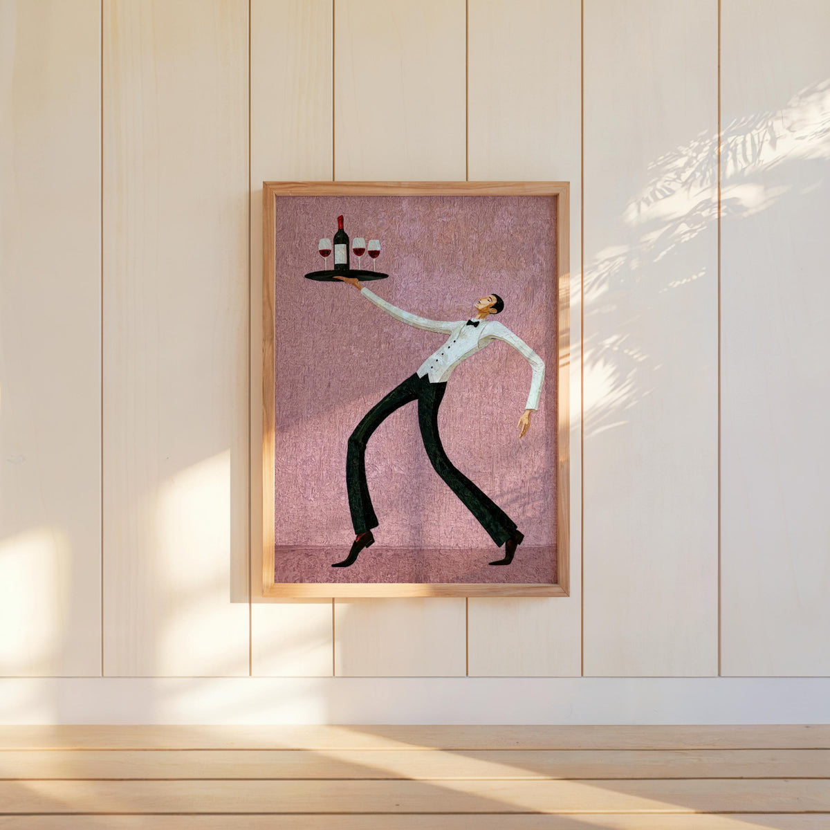 Dusty pink wine waiter art print standing on the floor by paneled wall, whimsical waiter poster for colorful dining room decor