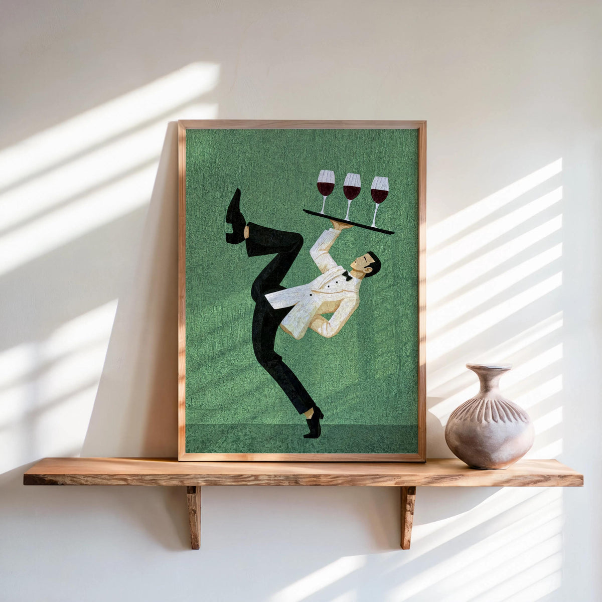 Framed green textured print on shelf, bold waiter silhouette balancing glasses, wine bar wall art, mid century modern bar art