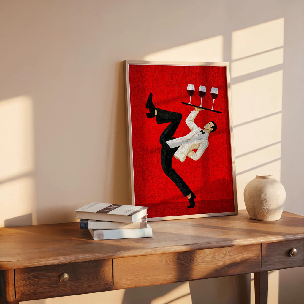 Red mid-century print propped on table near books, energetic waiter silhouette mid-dance, wine bar wall art, restaurant wall decor print