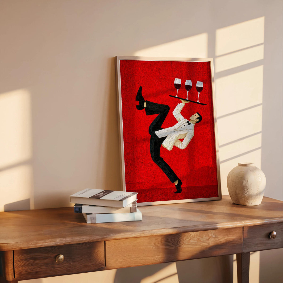 Red mid-century print propped on table near books, energetic waiter silhouette mid-dance, wine bar wall art, restaurant wall decor print