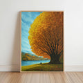 Autumn tree lake wall art leaning against white wall, golden tree landscape print by a bright blue lake