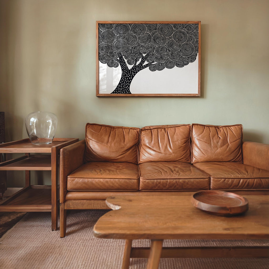 Black and white tree wall art over a leather sofa, Japandi wall art styling, abstract botanical focal point