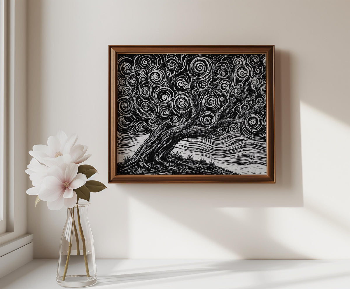 Framed black and white tree linocut print hung above a console with a vase, minimalist tree art print in warm neutral styling