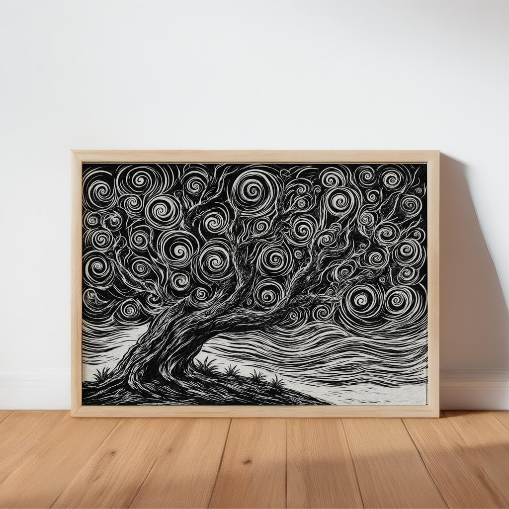 Horizontal black and white tree linocut print in a natural wood frame, leaning on hardwood floor, bold white carved lines