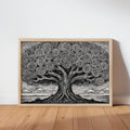 Horizontal black and white tree of life wall art, framed in natural wood, leaning on oak floor.