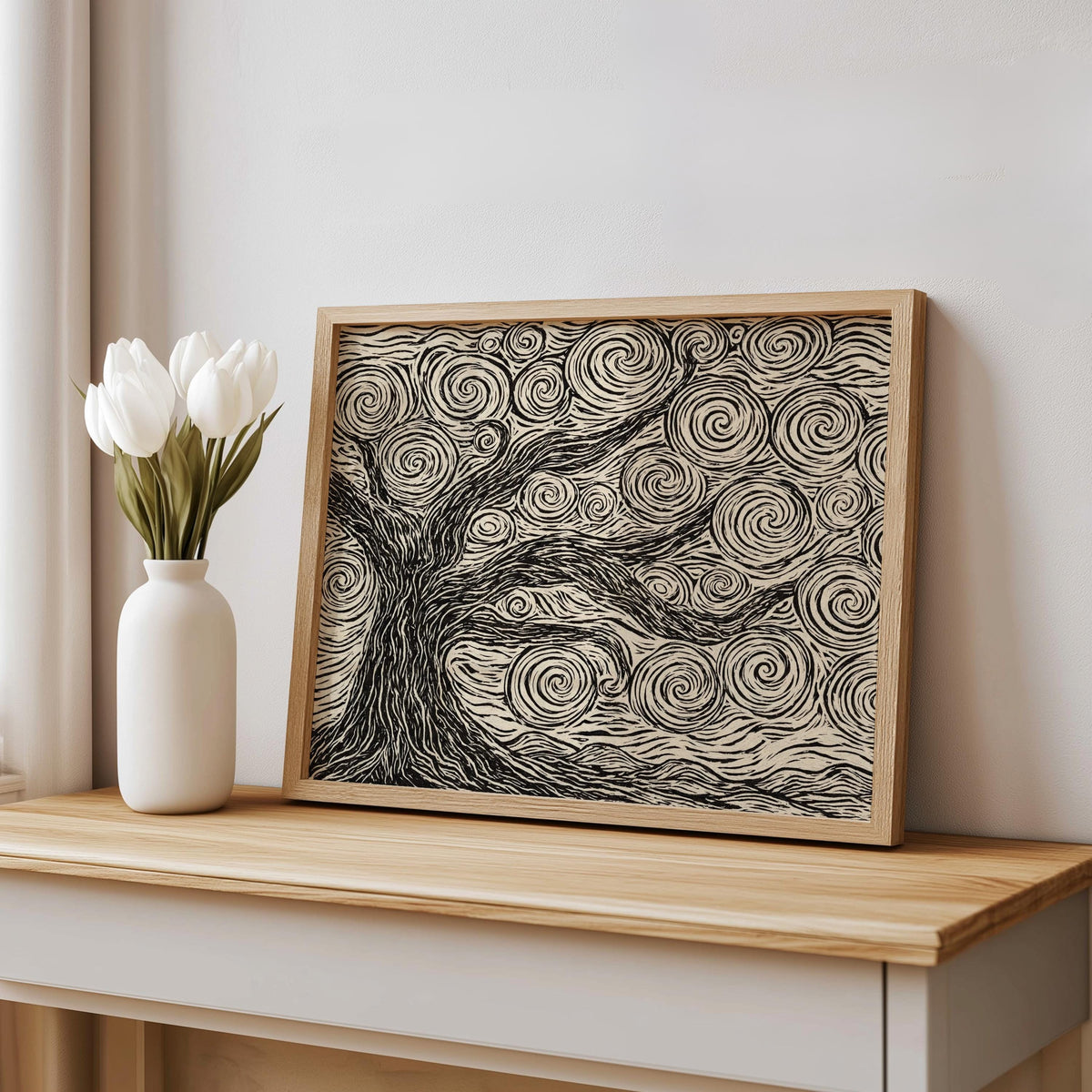 Leaning on mantel beside a white vase, wood framed linocut tree print, neutral tree wall art in sunlight