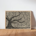 Natural wood frame resting on a floor, linocut tree print in cream and charcoal, neutral tree wall art