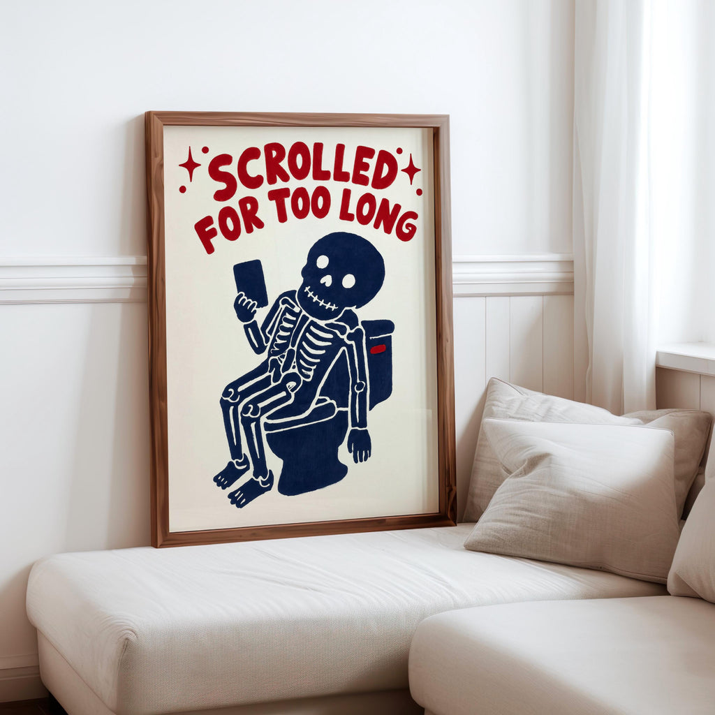 Funny skeleton bathroom art propped on a sofa cushion, creepy cute skeleton art with bold red distressed typography