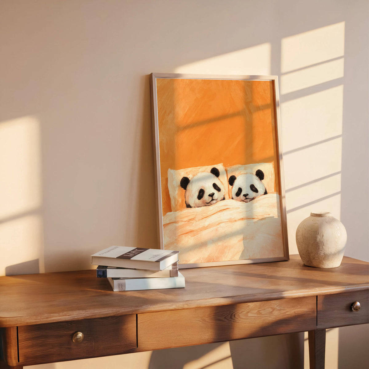 Orange sleeping panda wall art propped on a desk, late afternoon light and books, cuddling panda print for bedroom