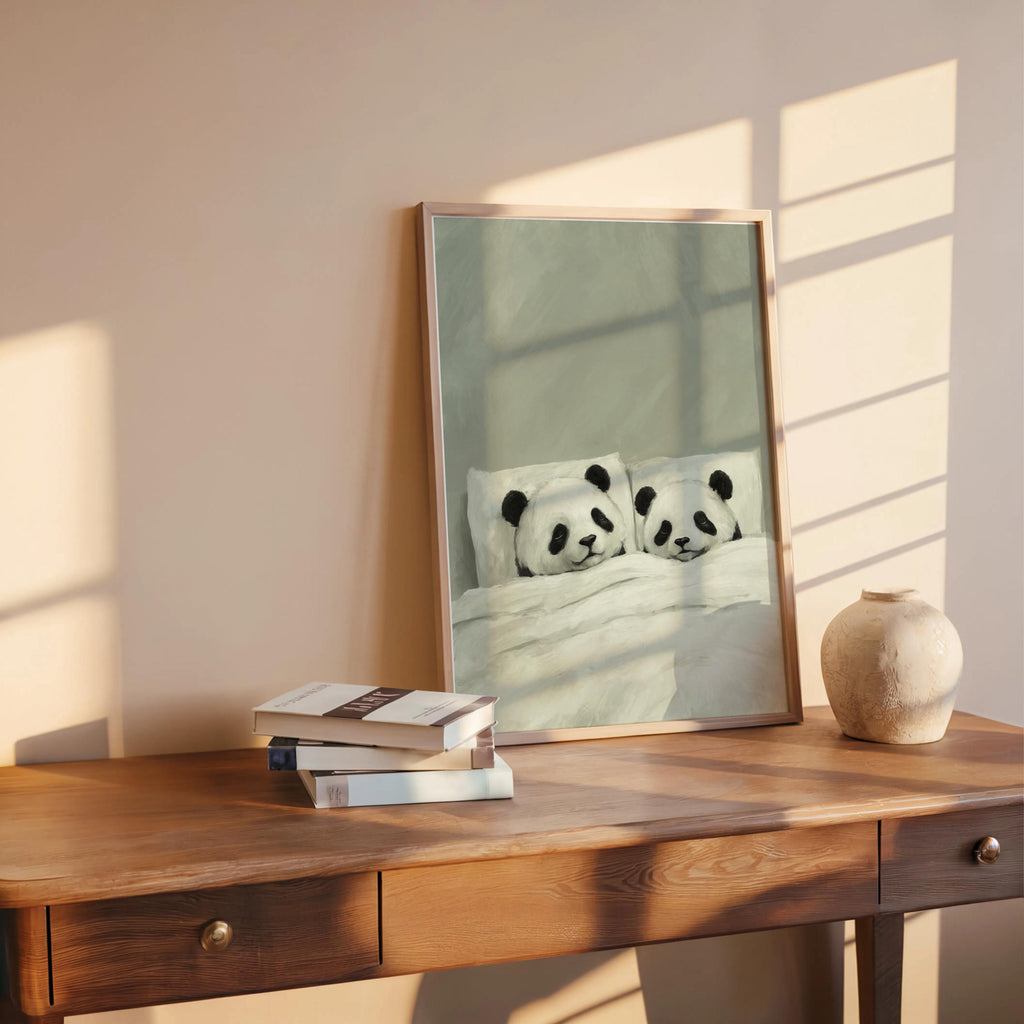 Sage sleeping panda wall art leaning on a rustic desk, warm light from window, panda couple print for cozy decor