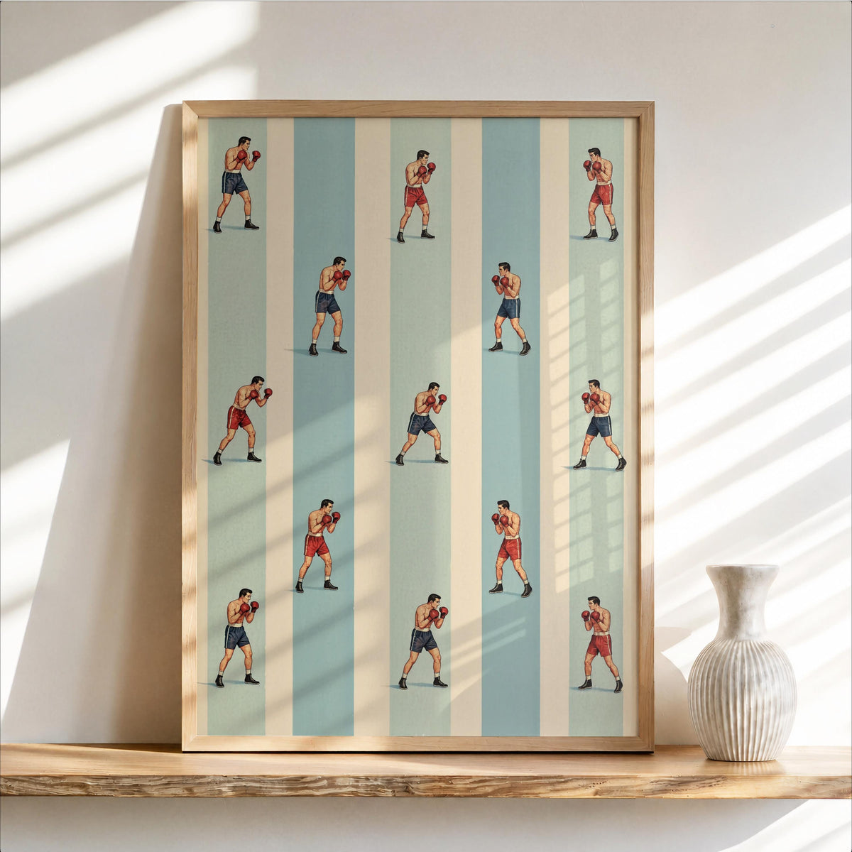 Framed vertical print leaning on a shelf, repeated boxer illustrations on muted striped field, vintage boxing wall art.