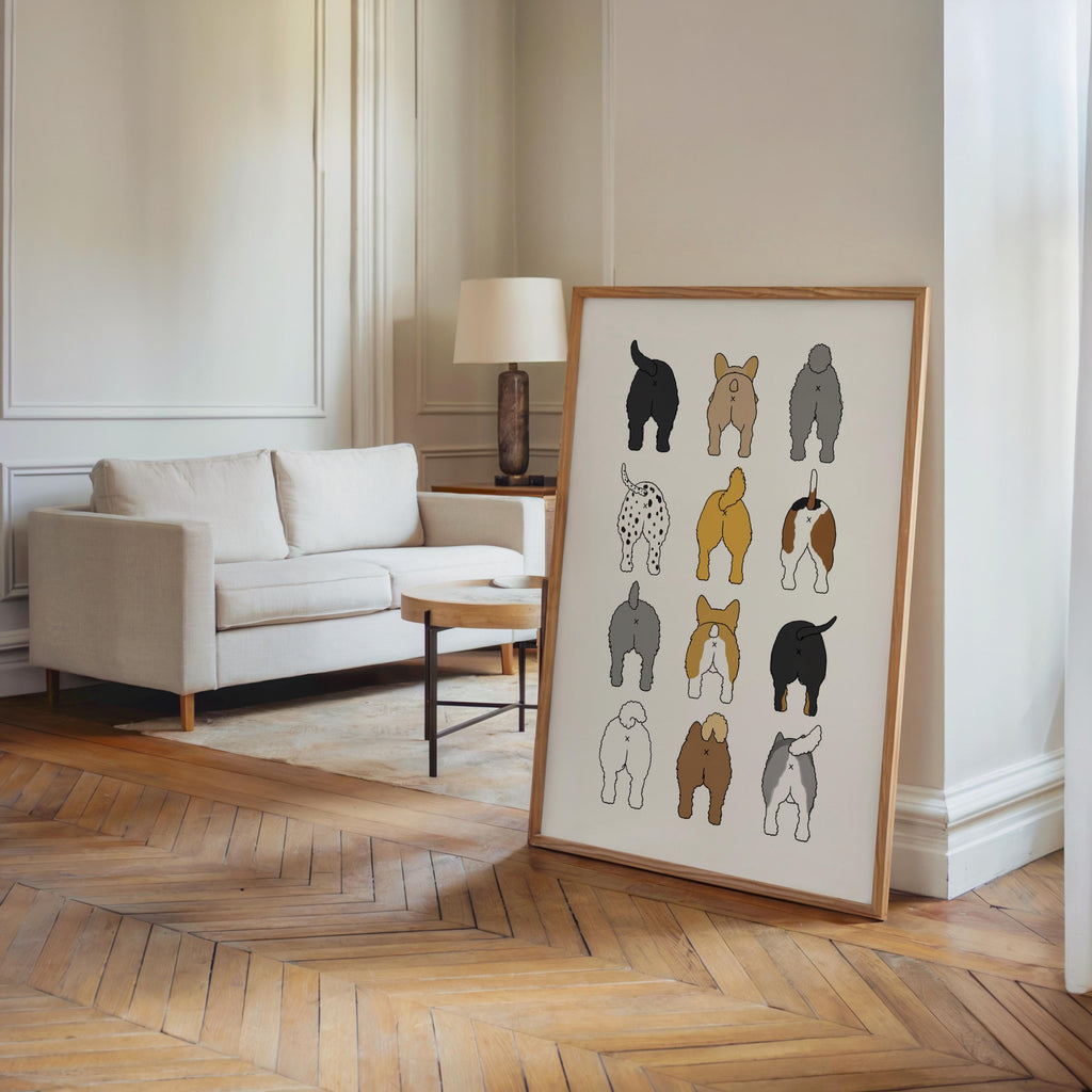Large framed print leaning by an open doorway on parquet floor, minimalist living room styling, dog butt print as housewarming bathroom decor
