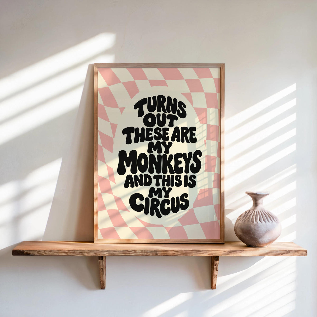 Blush pastel groovy checkerboard poster leaning on shelf, bold funny quote wall art, not my circus not my monkeys wall art