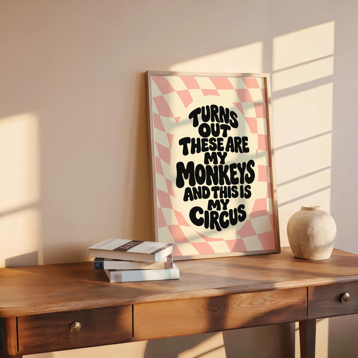 Blush pink print staged on wood table with soft light, funny kitchen wall decor styling, not my circus not my monkeys wall art