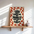 Framed red groovy checkerboard art print on a shelf, bold wavy type, not my circus not my monkeys wall art