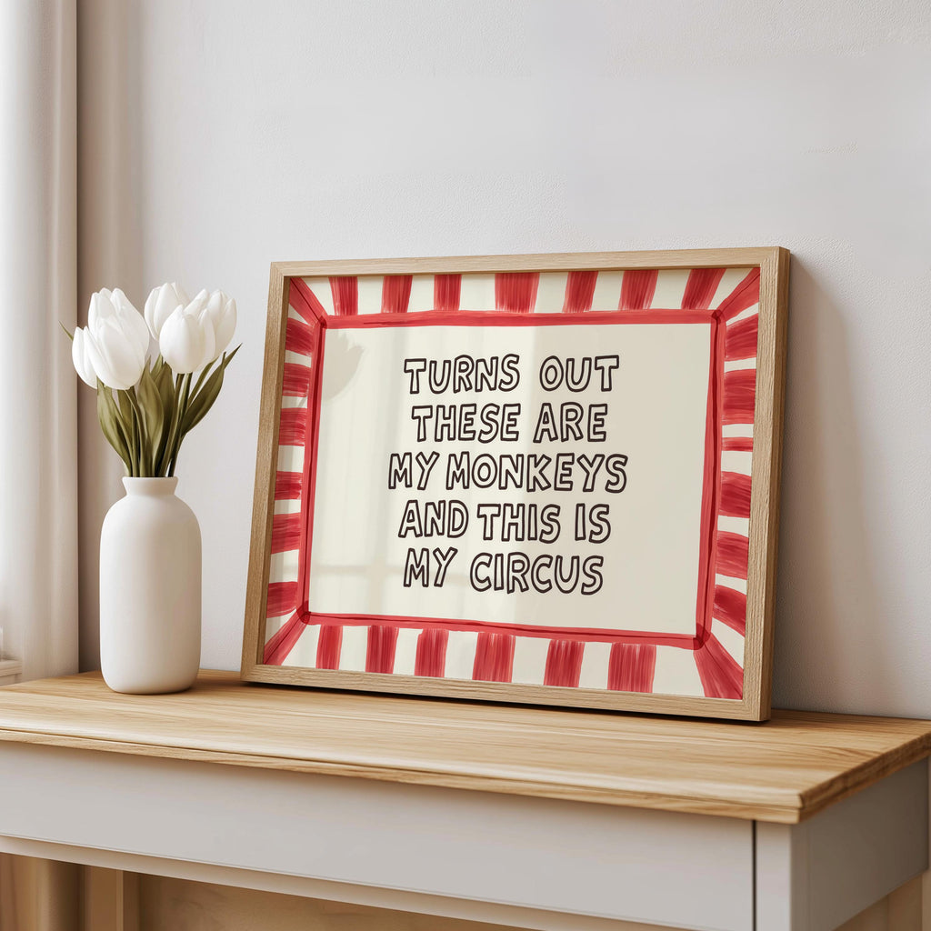 Red striped framed print leaning on console beside vase, playful hand-drawn type, funny housewarming gift idea, funny quote wall art.