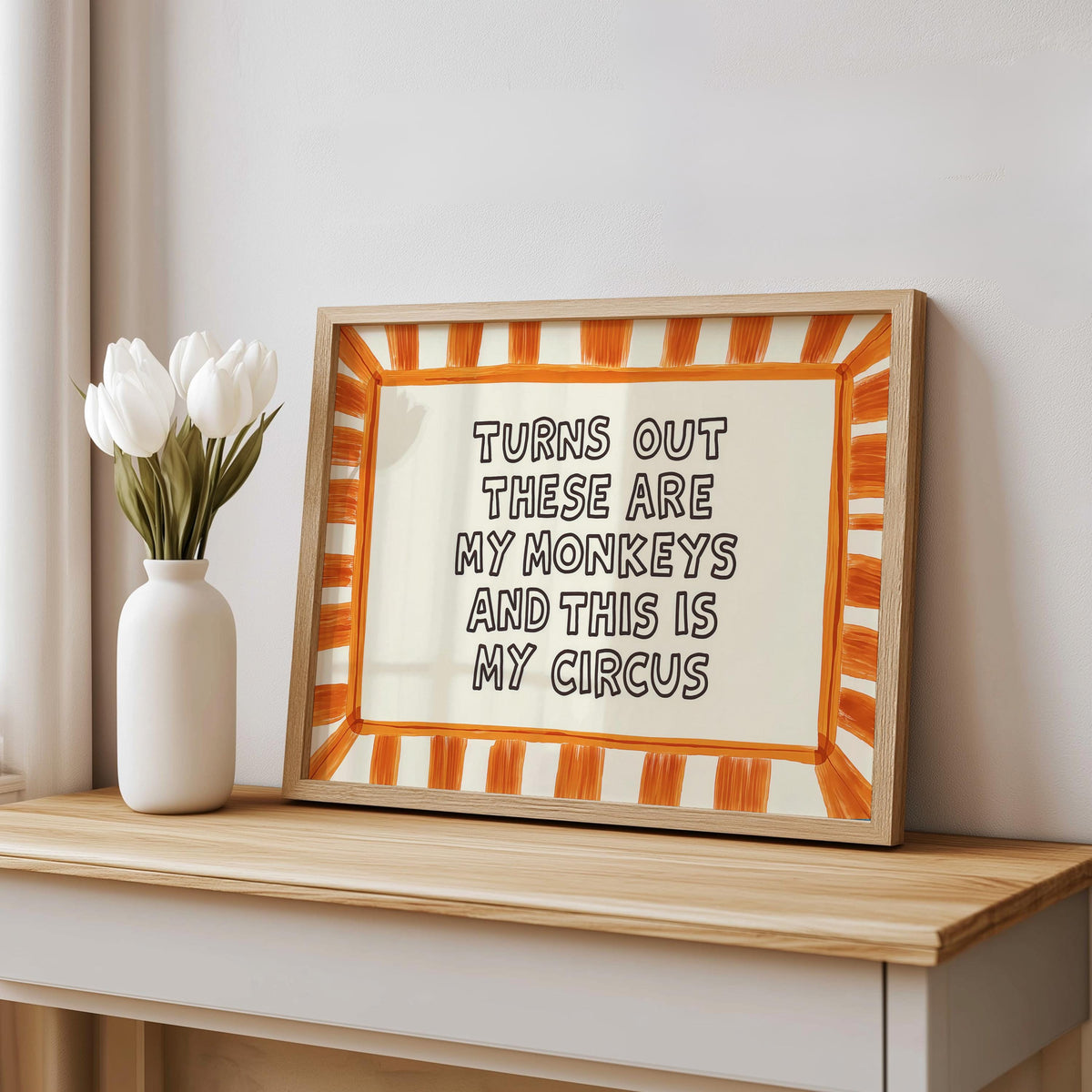 Orange striped framed print on console with white vase, bold striped border art print, funny family wall decor, funny quote wall art.