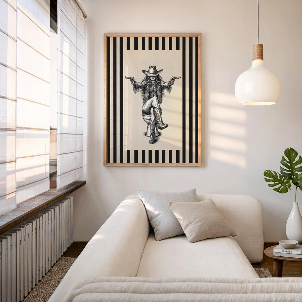 Framed cowgirl on toilet print hung above sofa, neutral modern living room, funny western restroom decor