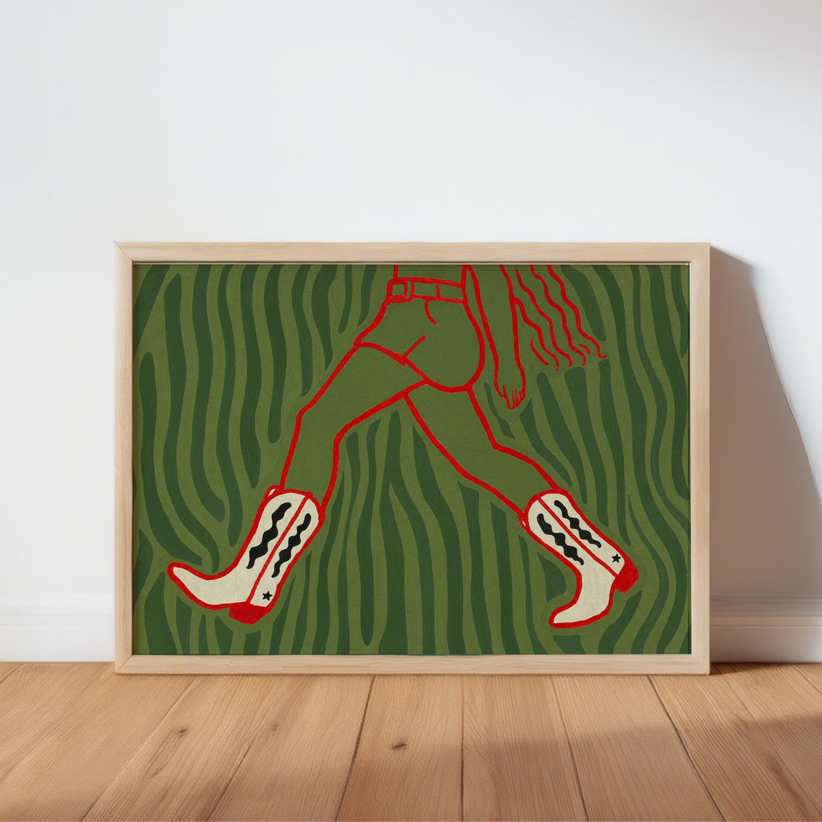 Cowgirl wall art print, green and black zebra-like background, red cowboy boots outlined, unframed on floor