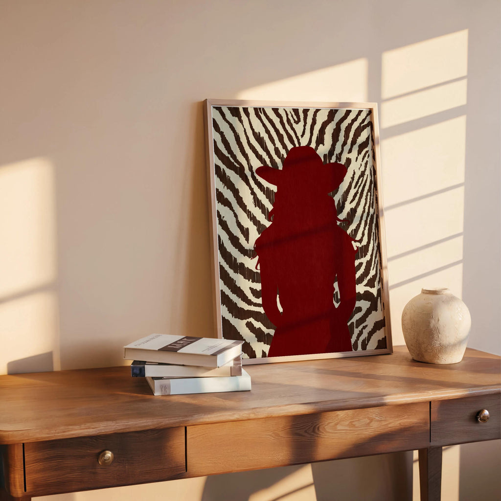 Zebra print cowgirl wall art styled on rustic desk, red cowgirl silhouette, contemporary western flair