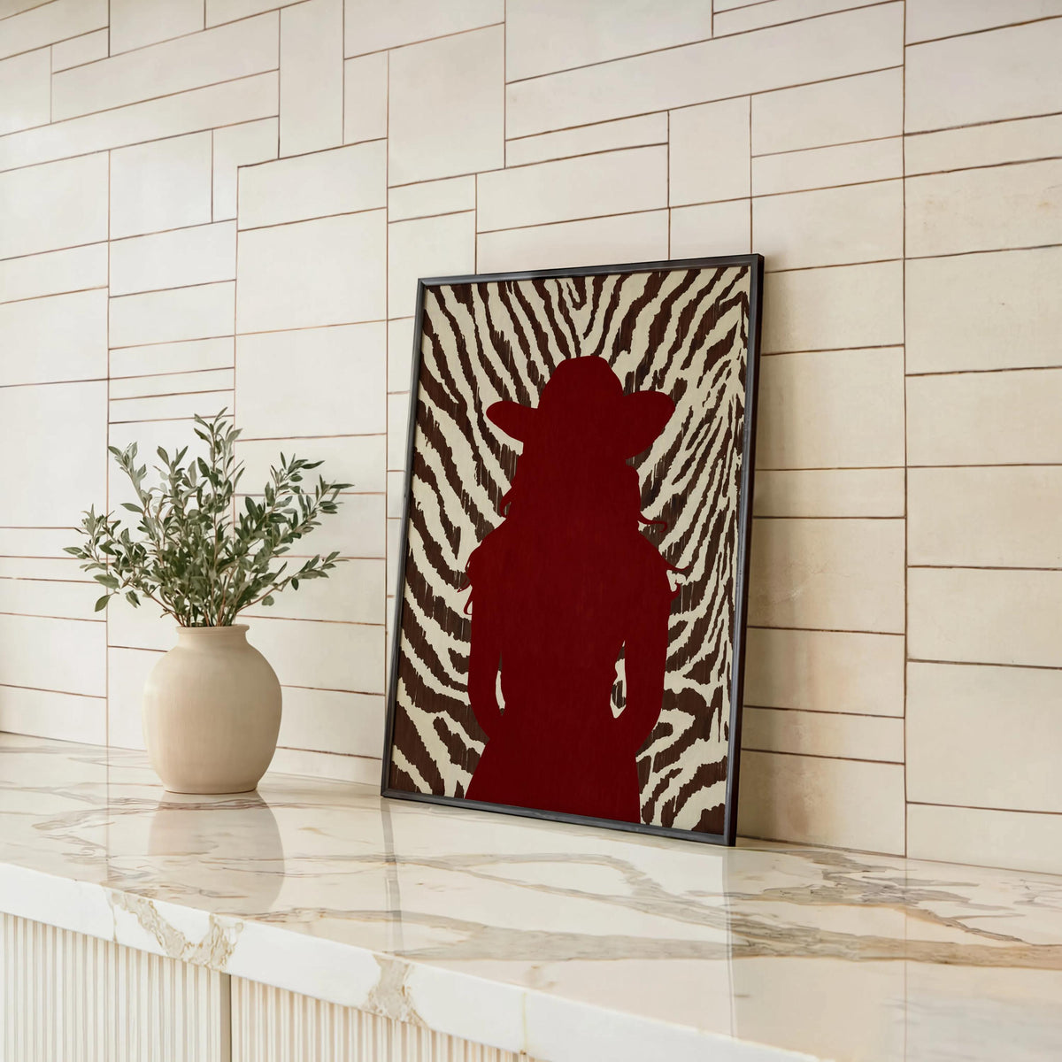 Leaning frame against shiplap, bold red cowgirl poster styled with plant, fashionable western print display