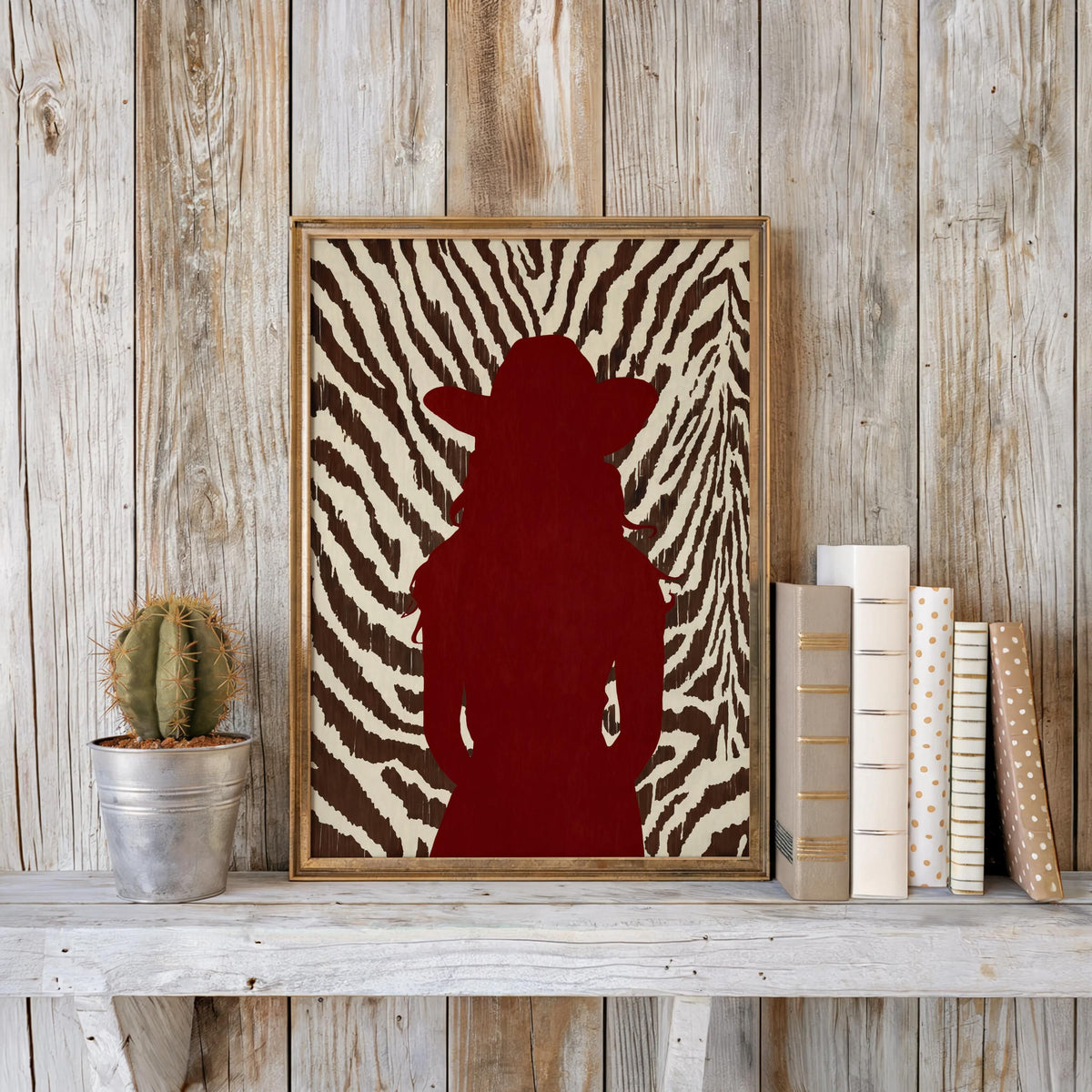 Rustic mantel display, framed red cowgirl poster paired with cactus, stylish animal print western decor setup