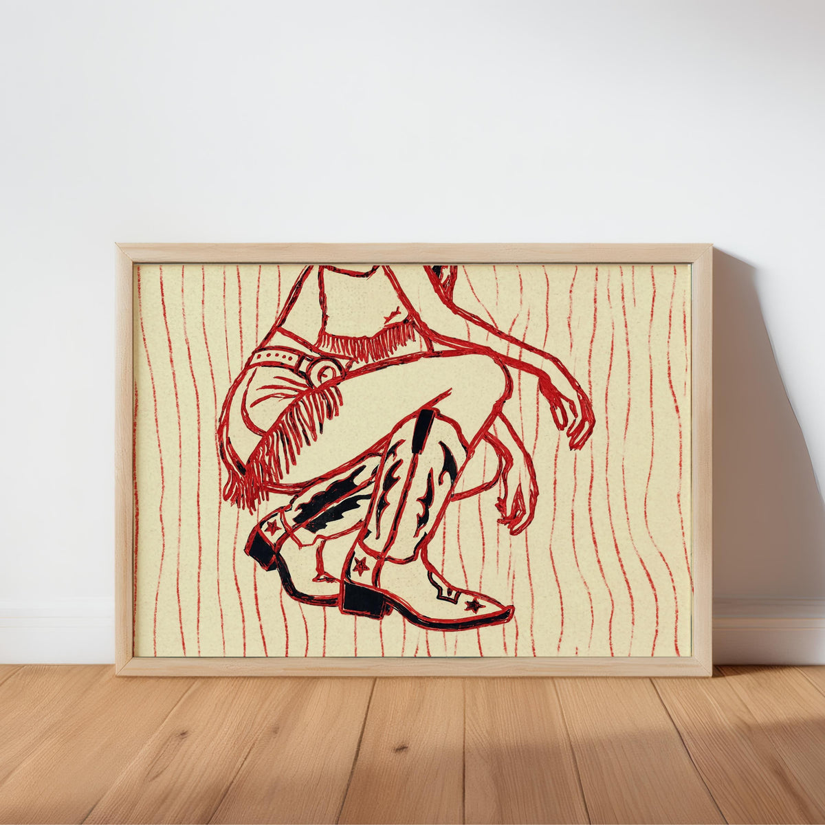 Framed print leaning on wood floor, western cowgirl wall art with retro red wavy stripes on warm cream