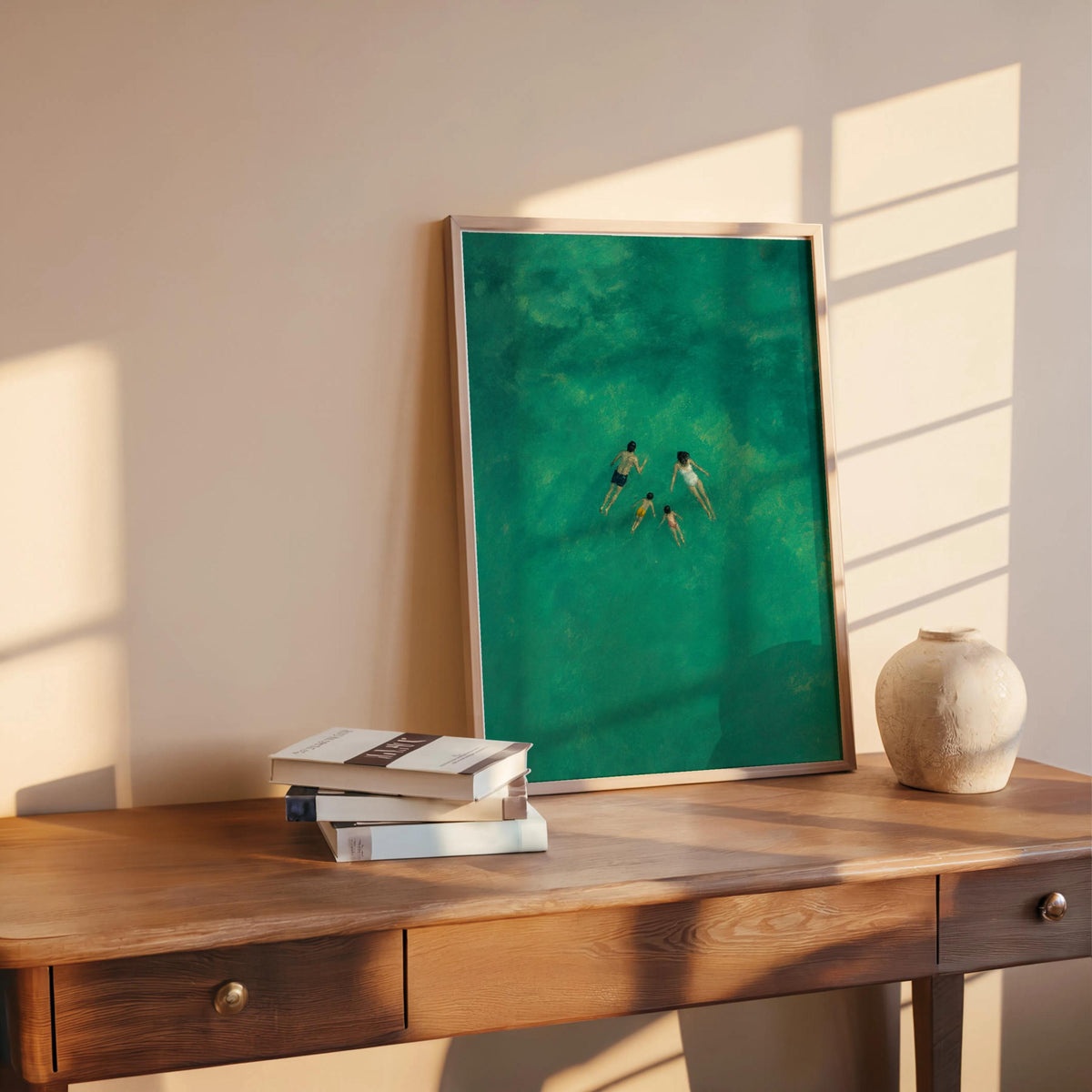 Family swimming wall art on rustic desk with books and ceramic vase, sunlight across the frame