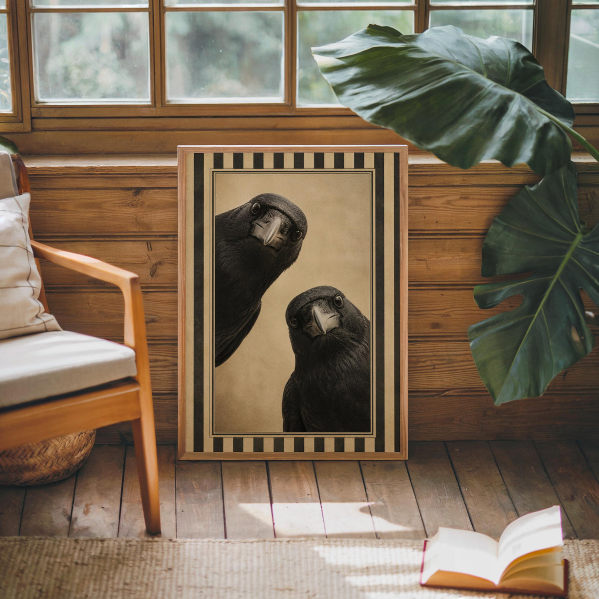 Black bird wall decor leaning by a bright window with a large houseplant, moody antique beige, gothic bird poster vibe