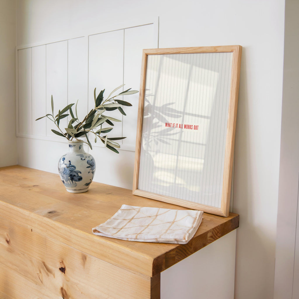 Wood table styling, what if it all works out print on archival paper, plant and folded linen nearby